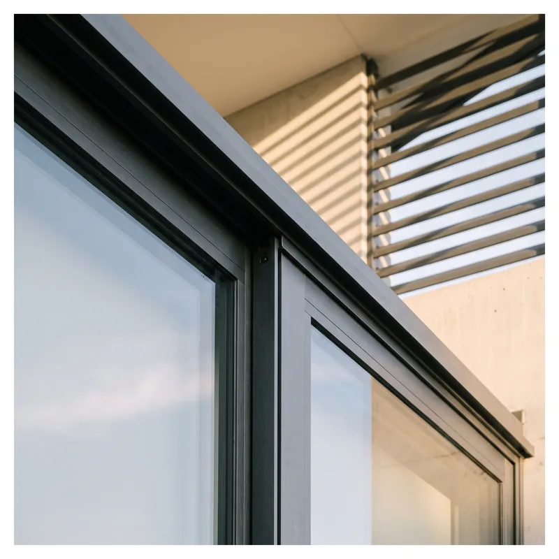 Rendered close-up of an aluminium window frame and external shading louvres