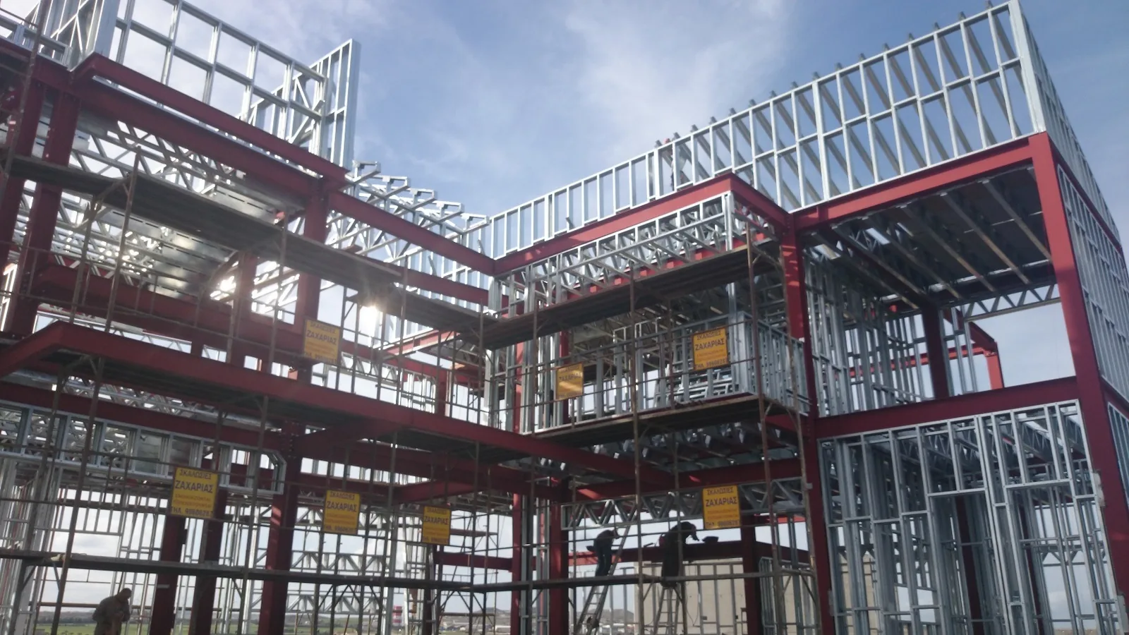 Steel roof rafters and columns joined above galvanized wall studs